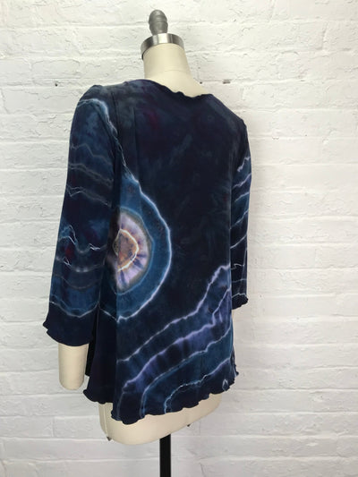 Long sleeve hand-dyed bamboo/cotton jersey tee with a flared fit, featuring bold spiral and lightning designs in deep indigo, violet, magenta, and pale blue.