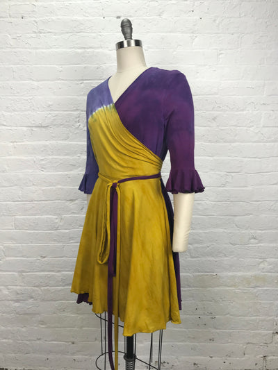 Flamenco Wrap Dress in Violet Sunrise - Soft to the touch bamboo jersey fabric makes this knee length wrap dress in gold and violet - left view