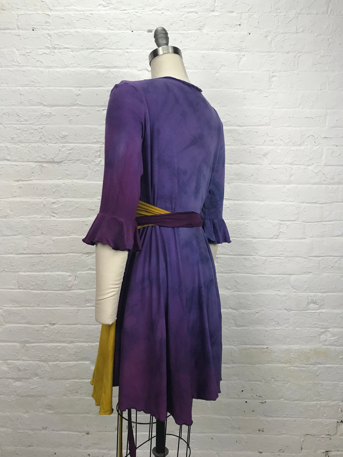 Flamenco Wrap Dress in Violet Sunrise - Soft to the touch bamboo jersey fabric makes this knee length wrap dress in gold and violet - left back view