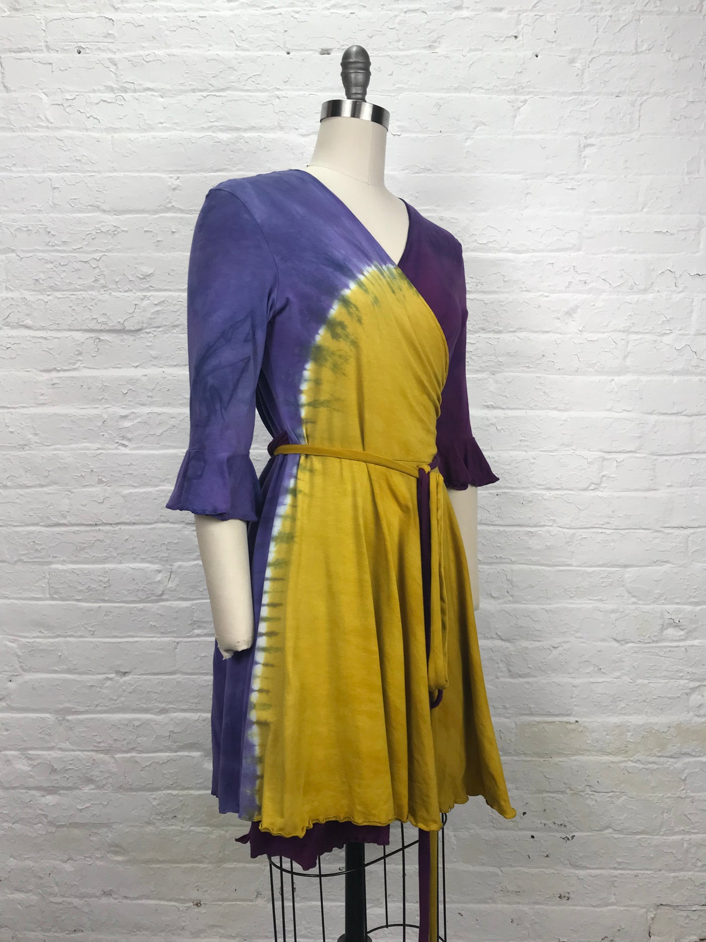 Flamenco Wrap Dress in Violet Sunrise - a colorful wrap dress in purples, violet and gold, made of cozy bamboo jersey which feels great on the skin - right front/side 3/4 view